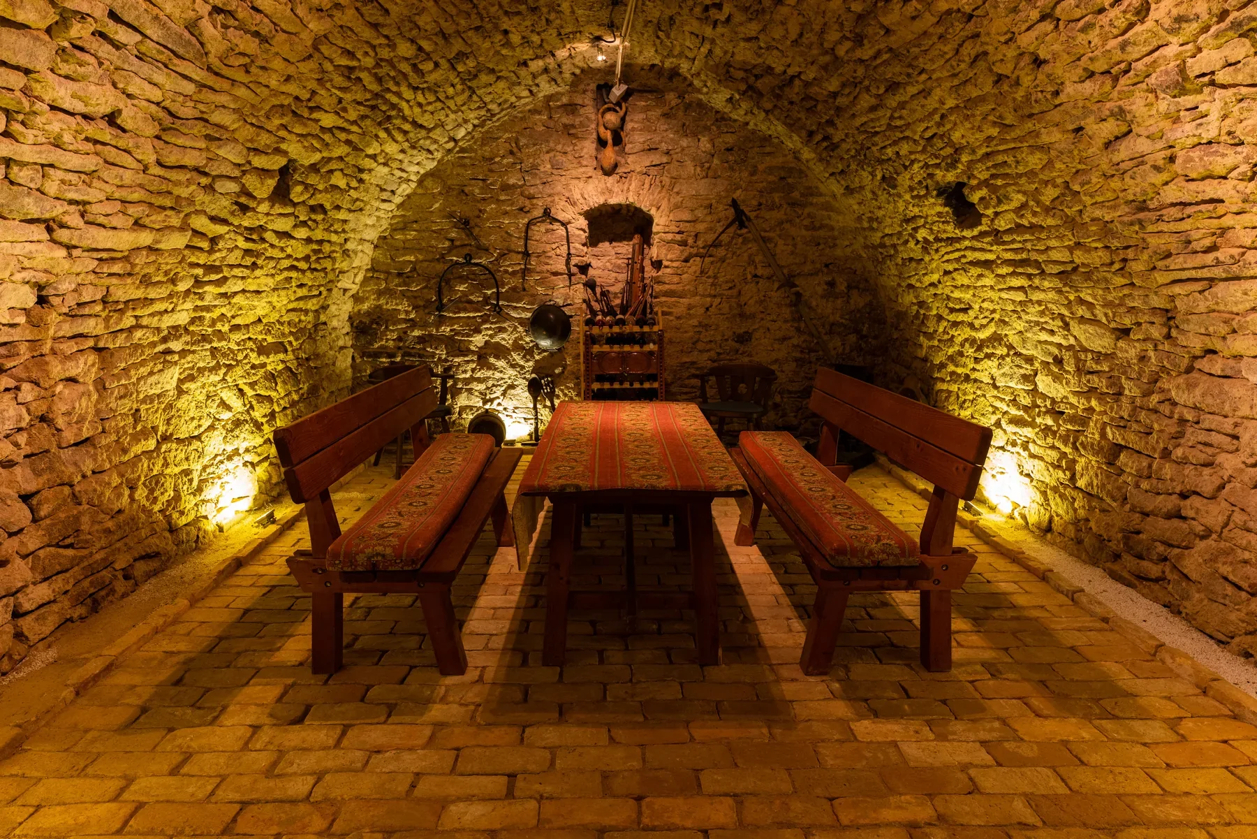 Historic vaulted cellar at Tabódy Villa with long table and benches