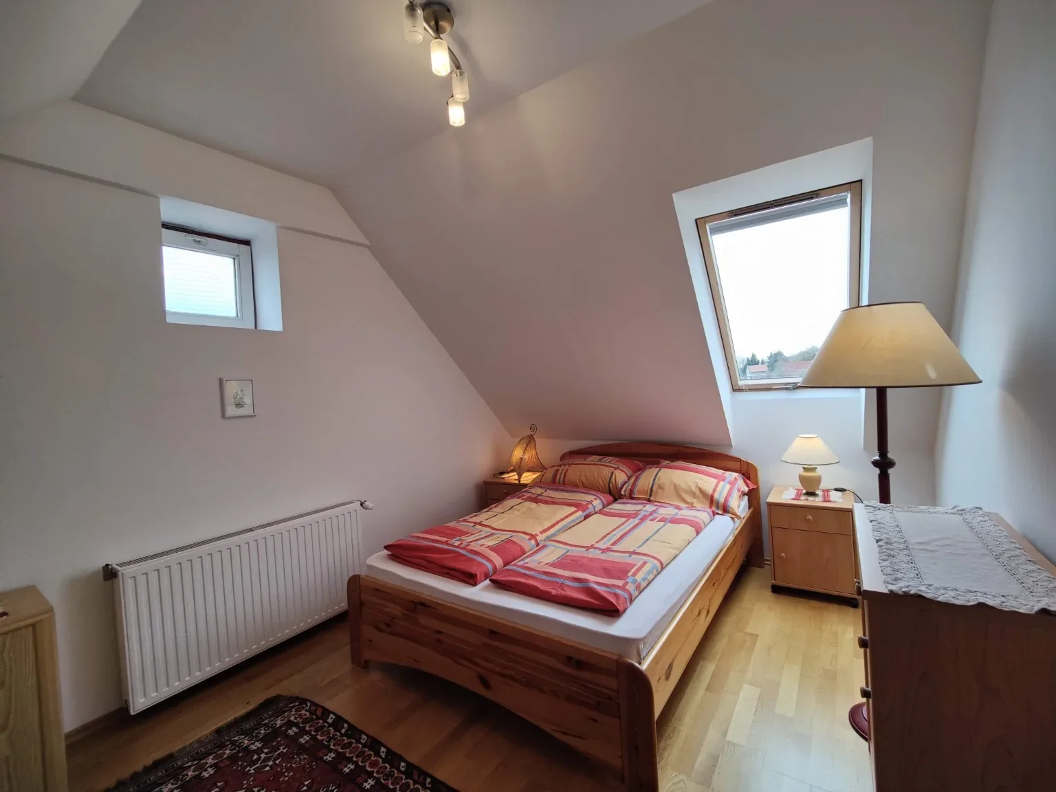 Rooftop bedroom with double bed beneath the sloping roof