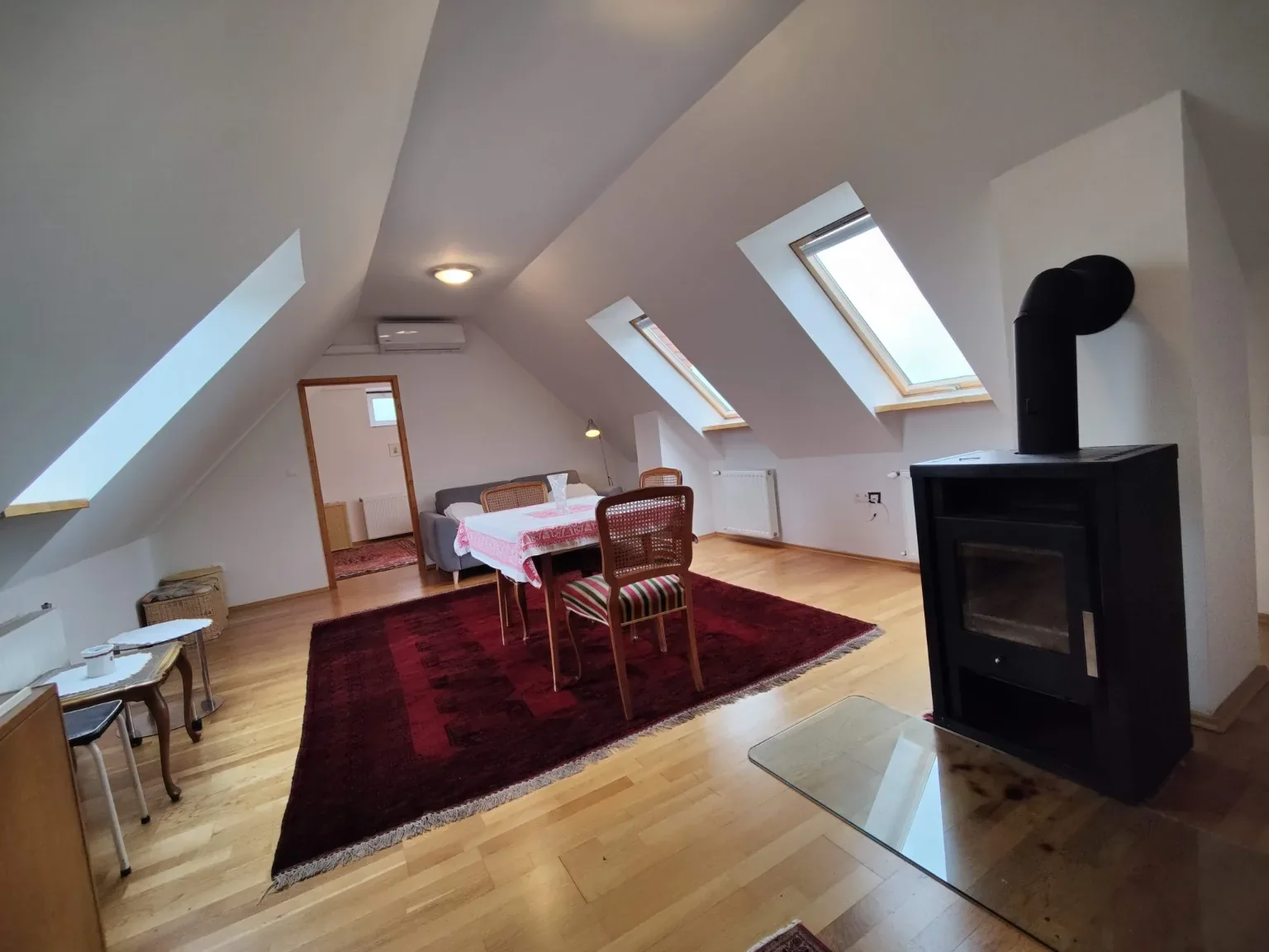Spacious Rooftop living area with fireplace and skylights
